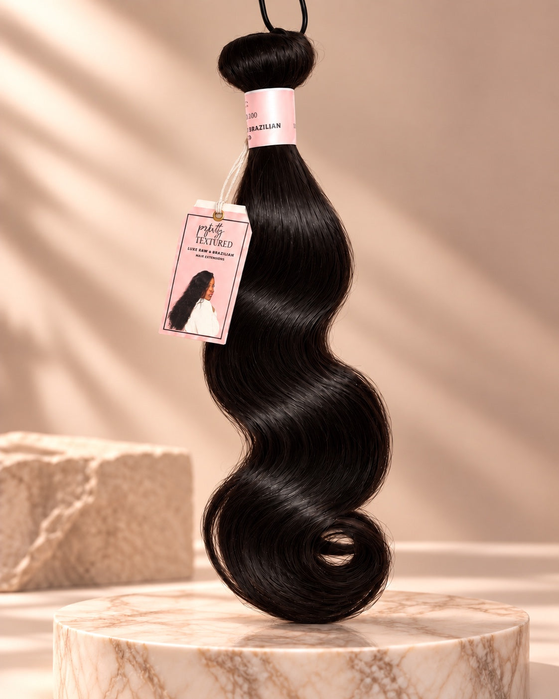 Perfectly Textured Brazilian Body Wave hair extension bundle with soft flowing waves and pink label